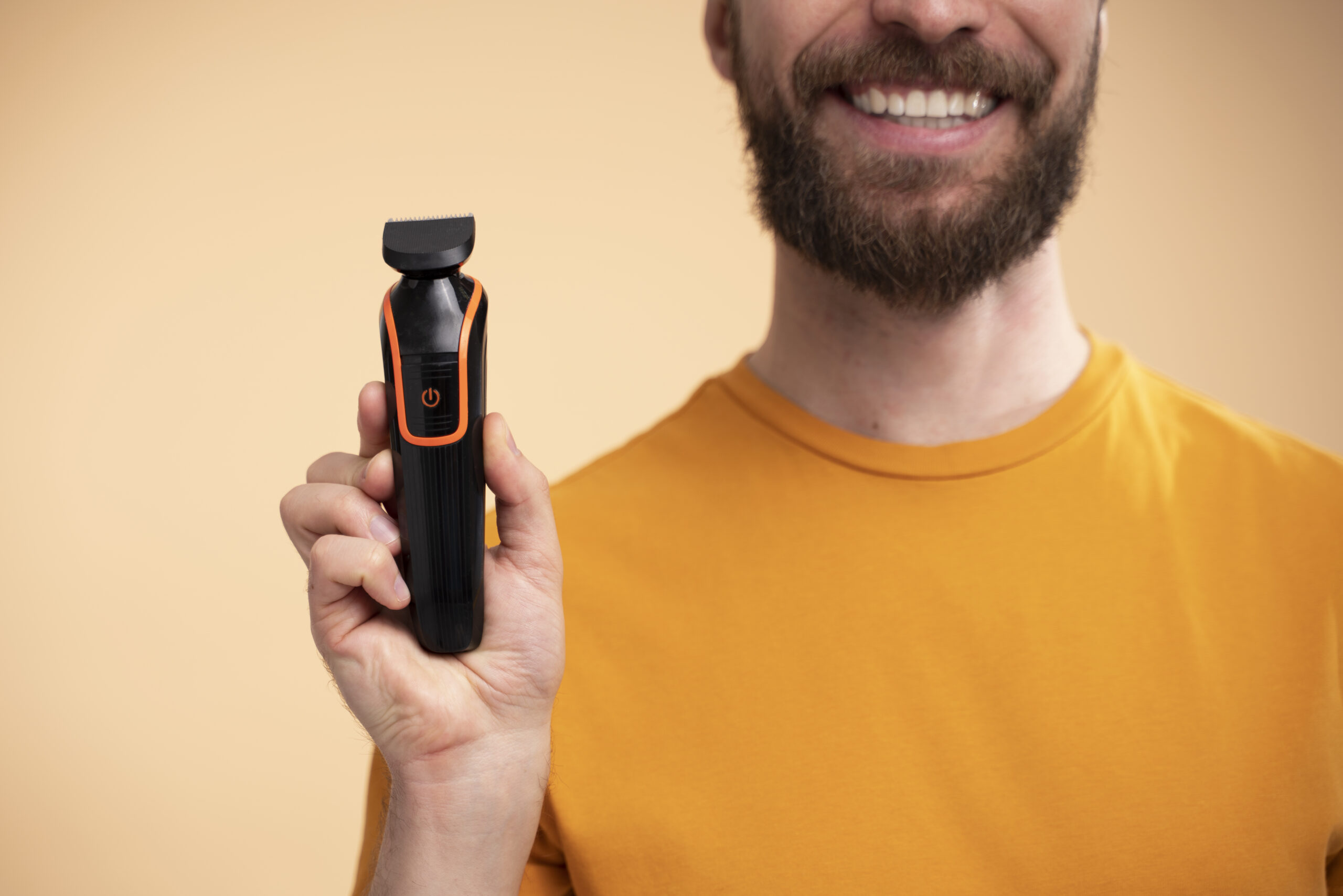 portrait-excited-young-man-showing-his-shaving-machine portrait-excited-young-man-showing-his-shaving-machine.